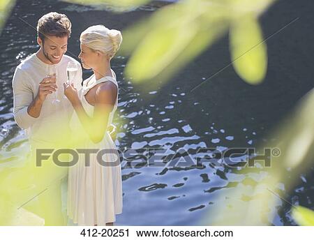 Couple drinking champagne by pool View Large Photo Image Stock Image - Couple drinking champagne by pool. Fotosearch