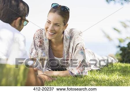 Couple drinking champagne outdoors View Large Photo Image Stock Photo - Couple drinking champagne outdoors. Fotosearch