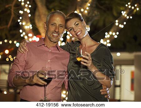 Couple drinking wine together outdoors View Large Photo Image Stock Photograph - Couple drinking wine together outdoors. Fotosearch