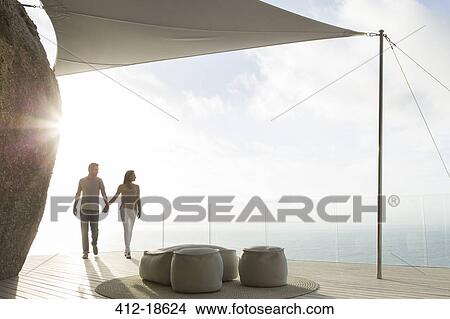 Couple holding hands on modern balcony View Large Photo Image Picture - Couple holding hands on modern balcony. Fotosearch