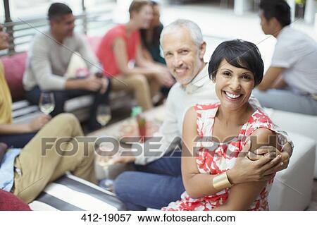 Stock Photo - Couple hugging at party. Fotosearch