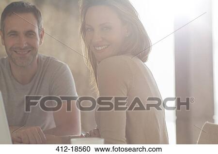 Couple smiling at breakfast table View Large Photo Image Stock Image - Couple smiling at breakfast table. Fotosearch