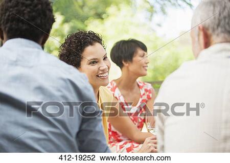 Couple talking at party View Large Photo Image Stock Image - Couple talking at party. Fotosearch