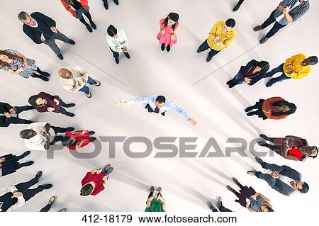 Stock Photo - Crowd around businessman with arms outstretched. Fotosearch
