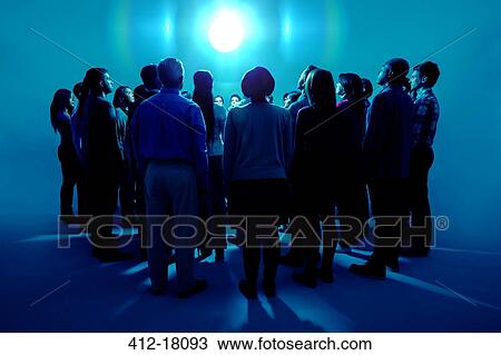 Crowd standing around bright light View Large Photo Image Stock Image - Crowd standing around bright light. Fotosearch