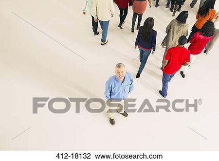 Crowd walking away from man View Large Photo Image Stock Image - Crowd walking away from man. Fotosearch