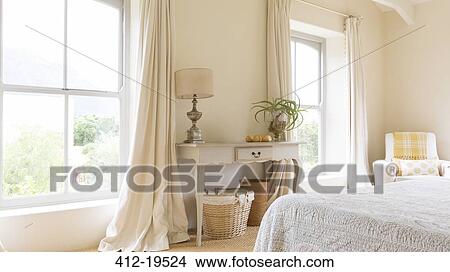 Picture - Curtain and vanity table in rustic bedroom. Fotosearch
