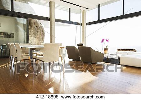 Dining and living area in modern house View Large Photo Image Stock Photo - Dining and living area in modern house. Fotosearch