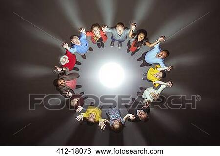 Stock Photograph - Diverse crowd around bright light. Fotosearch