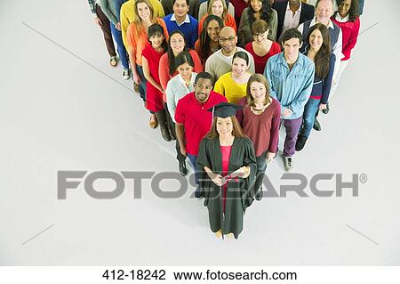 Diverse crowd behind confident graduate View Large Photo Image Stock Image - Diverse crowd behind confident graduate. Fotosearch