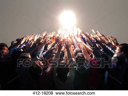 Diverse crowd reaching for bright light View Large Photo Image Stock Photo - Diverse crowd reaching for bright light. Fotosearch