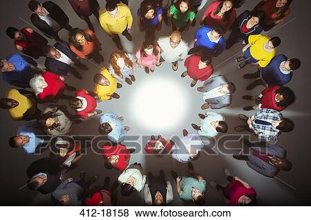 Diverse crowd standing around bright light View Large Photo Image Stock Photo - Diverse crowd standing around bright light. Fotosearch
