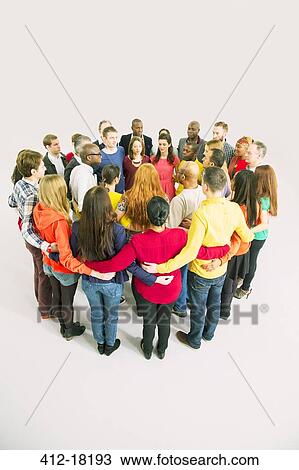 Diverse group forming huddle View Large Photo Image Stock Image - Diverse group forming huddle. Fotosearch