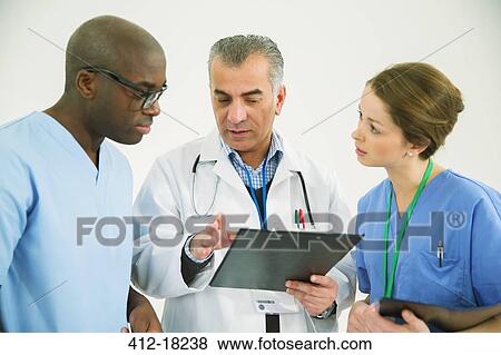 Stock Photo - Doctor and nurses with clipboard. Fotosearch