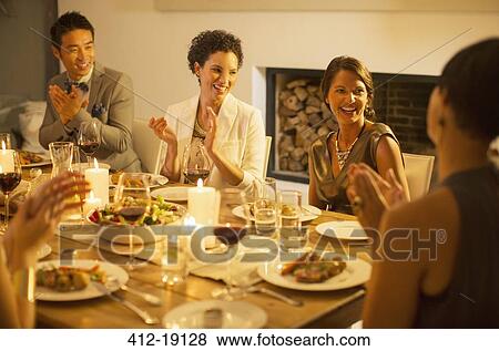 Friends applauding at dinner party View Large Photo Image Stock Photo - Friends applauding at dinner party. Fotosearch