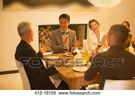 Friends applauding at dinner party View Large Photo Image Stock Photography - Friends applauding at dinner party. Fotosearch