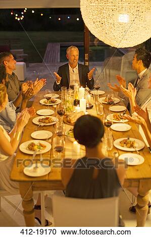 Friends applauding man at dinner party View Large Photo Image Stock Image - Friends applauding man at dinner party. Fotosearch