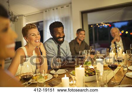 Friends laughing at dinner party View Large Photo Image Stock Image - Friends laughing at dinner party. Fotosearch