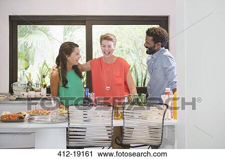 Friends laughing at party View Large Photo Image Stock Image - Friends laughing at party. Fotosearch