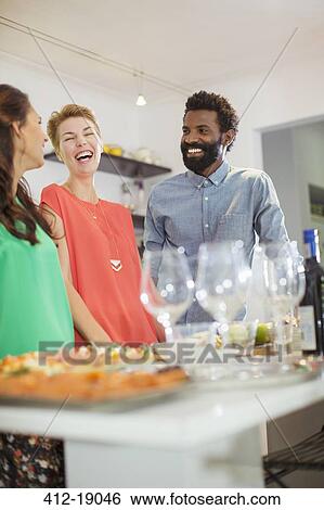 Friends laughing at party View Large Photo Image Stock Photograph - Friends laughing at party. Fotosearch