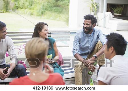 Stock Photograph - Friends laughing at party. Fotosearch