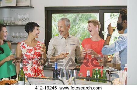Friends laughing together at party View Large Photo Image Stock Photography - Friends laughing together at party. Fotosearch