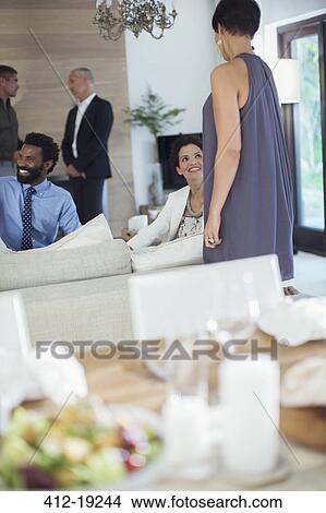 Friends relaxing at party View Large Photo Image Picture - Friends relaxing at party. Fotosearch