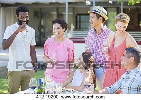 Friends relaxing together outdoors View Large Photo Image Stock Image - Friends relaxing together outdoors. Fotosearch