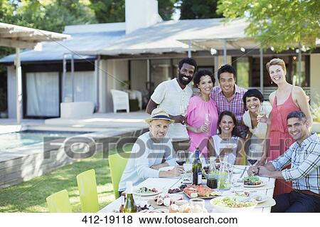 Friends smiling together at party View Large Photo Image Stock Photo - Friends smiling together at party. Fotosearch