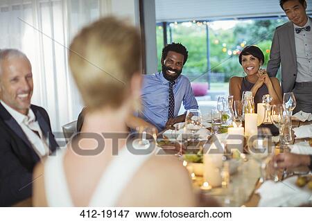 Friends talking at dinner party View Large Photo Image Stock Photo - Friends talking at dinner party. Fotosearch