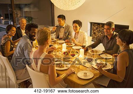 Friends talking at dinner party View Large Photo Image Stock Photo - Friends talking at dinner party. Fotosearch