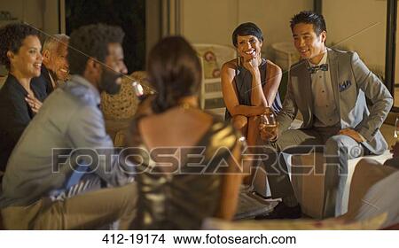 Friends talking at party View Large Photo Image Picture - Friends talking at party. Fotosearch