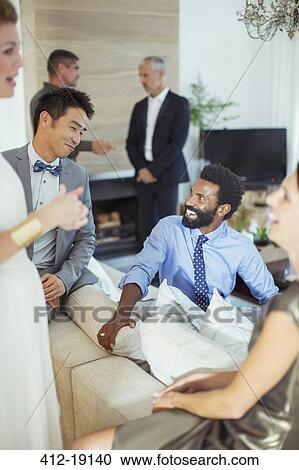 Friends talking at party View Large Photo Image Stock Image - Friends talking at party. Fotosearch