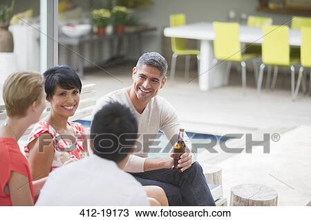 Friends talking at party View Large Photo Image Stock Image - Friends talking at party. Fotosearch