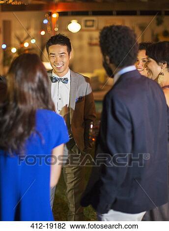 Friends talking at party View Large Photo Image Stock Image - Friends talking at party. Fotosearch