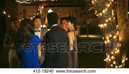 Friends talking at party View Large Photo Image Stock Image - Friends talking at party. Fotosearch