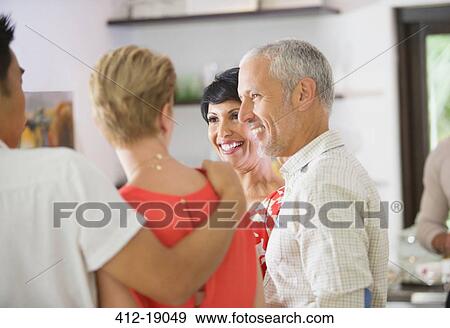 Stock Photo - Friends talking at party. Fotosearch