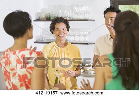Friends talking at party View Large Photo Image Stock Photo - Friends talking at party. Fotosearch