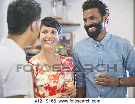 Friends talking at party View Large Photo Image Stock Photography - Friends talking at party. Fotosearch