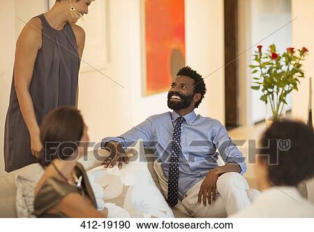 Friends talking at table outdoors View Large Photo Image Stock Image - Friends talking at table outdoors. Fotosearch