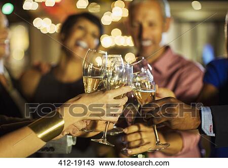 Friends toasting each other at party View Large Photo Image Stock Image - Friends toasting each other at party. Fotosearch