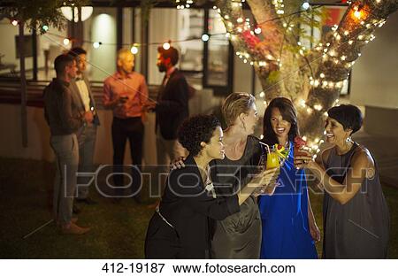 Friends toasting each other at party View Large Photo Image Stock Photo - Friends toasting each other at party. Fotosearch
