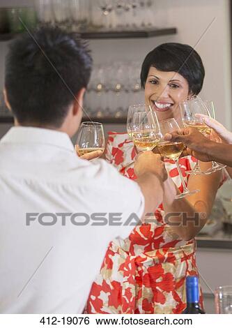 Friends toasting each other at party View Large Photo Image Stock Photograph - Friends toasting each other at party. Fotosearch