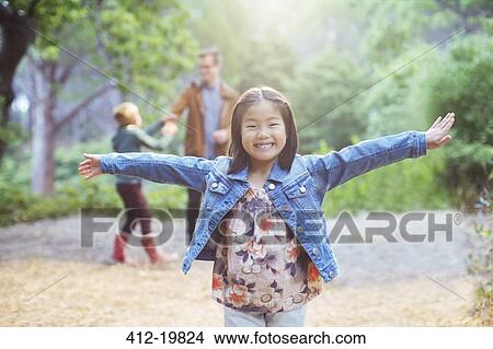 Picture - Girl cheering in forest. Fotosearch