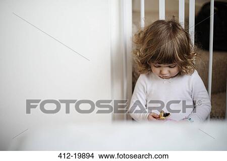 Girl eating snack on stairs View Large Photo Image Picture - Girl eating snack on stairs. Fotosearch