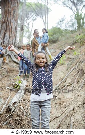 Stock Photo - Girl holding arms out in forest. Fotosearch
