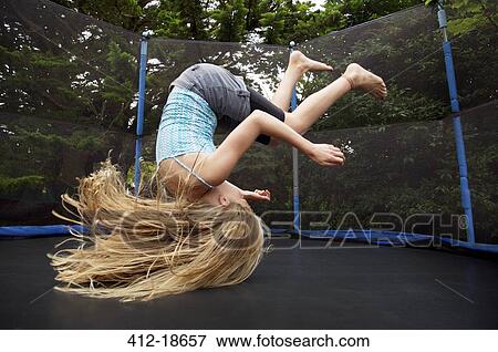 Girl jumping on trampoline outdoors View Large Photo Image Stock Photo - Girl jumping on trampoline outdoors. Fotosearch