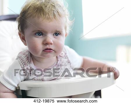 Girl sitting in high chair View Large Photo Image Stock Photography - Girl sitting in high chair. Fotosearch