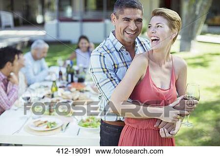 Laughing couple hugging outdoors View Large Photo Image Stock Image - Laughing couple hugging outdoors. Fotosearch
