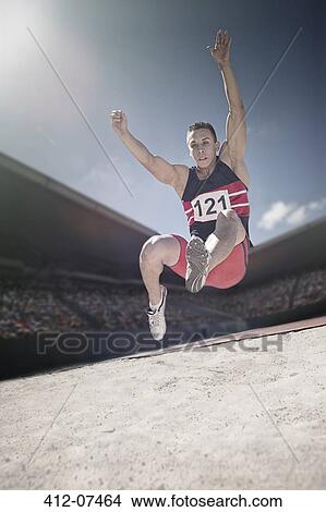 Long jumper above sand pit View Large Photo Image Picture - Long jumper above sand pit. Fotosearch